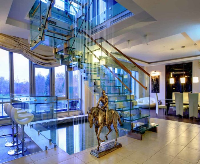 St. Petersburg Russia - December 16 2011: Bronze jockey on a horse in the interior of the living room in two-storey apartments near the glass staircase.