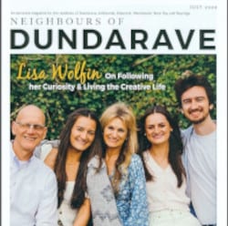 Group photo of five smiling people sitting closely against vibrant green foliage. The text at the top reads, Neighbours of Dundarave. The cover highlights an article featuring Lisa Wolfin, celebrated among home design experts for her innovative style.